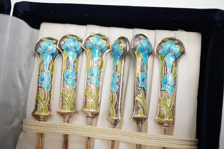 A mid 20th century cased set of six Danish gilt sterling and polychrome enamel coffee spoons, by Egon Lauridson, 94mm, together with one other set of six white metal and enamelled teaspoons, stamped 'silver'. Condition -